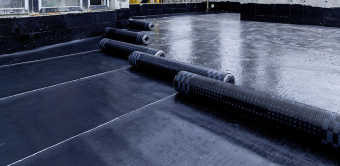 Laying and installation of roofing, bituminous waterproofing of an apartment building. Rolled roofing waterproofing of concrete slabs of stylobate. Heating and melting of bituminous roofing material.